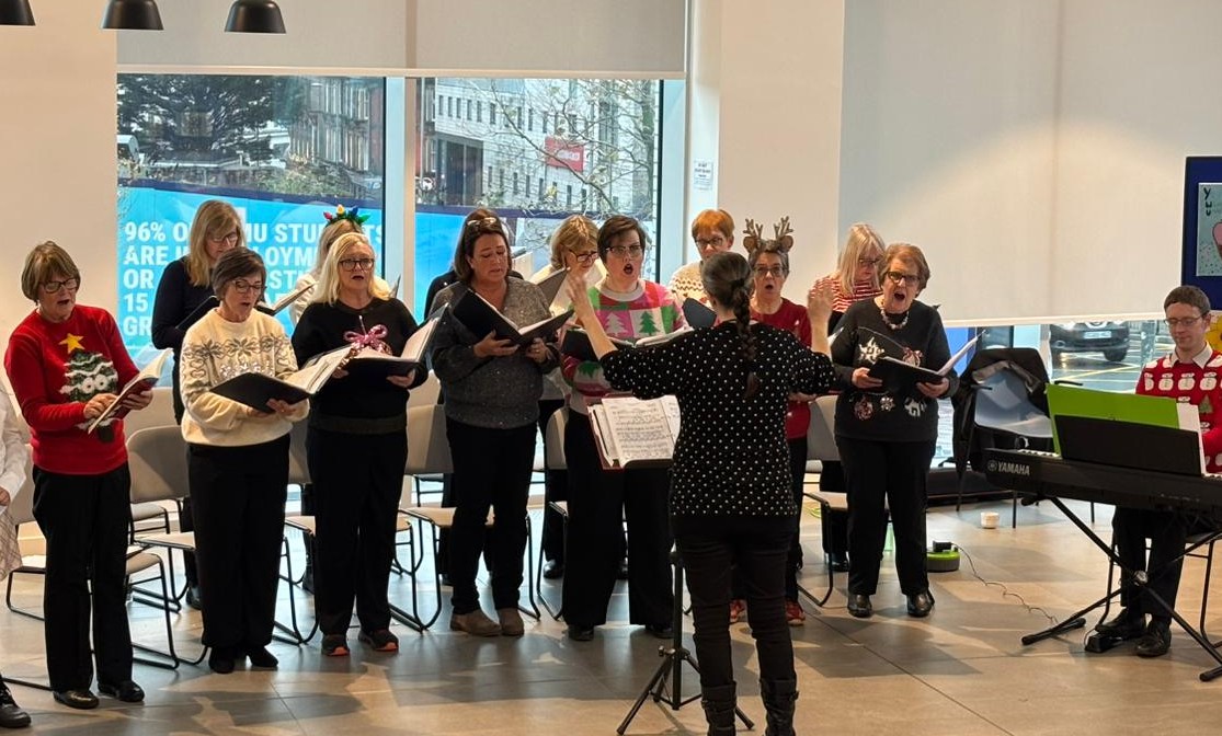 One Achord choir members singing carols for charity in Liverpool.