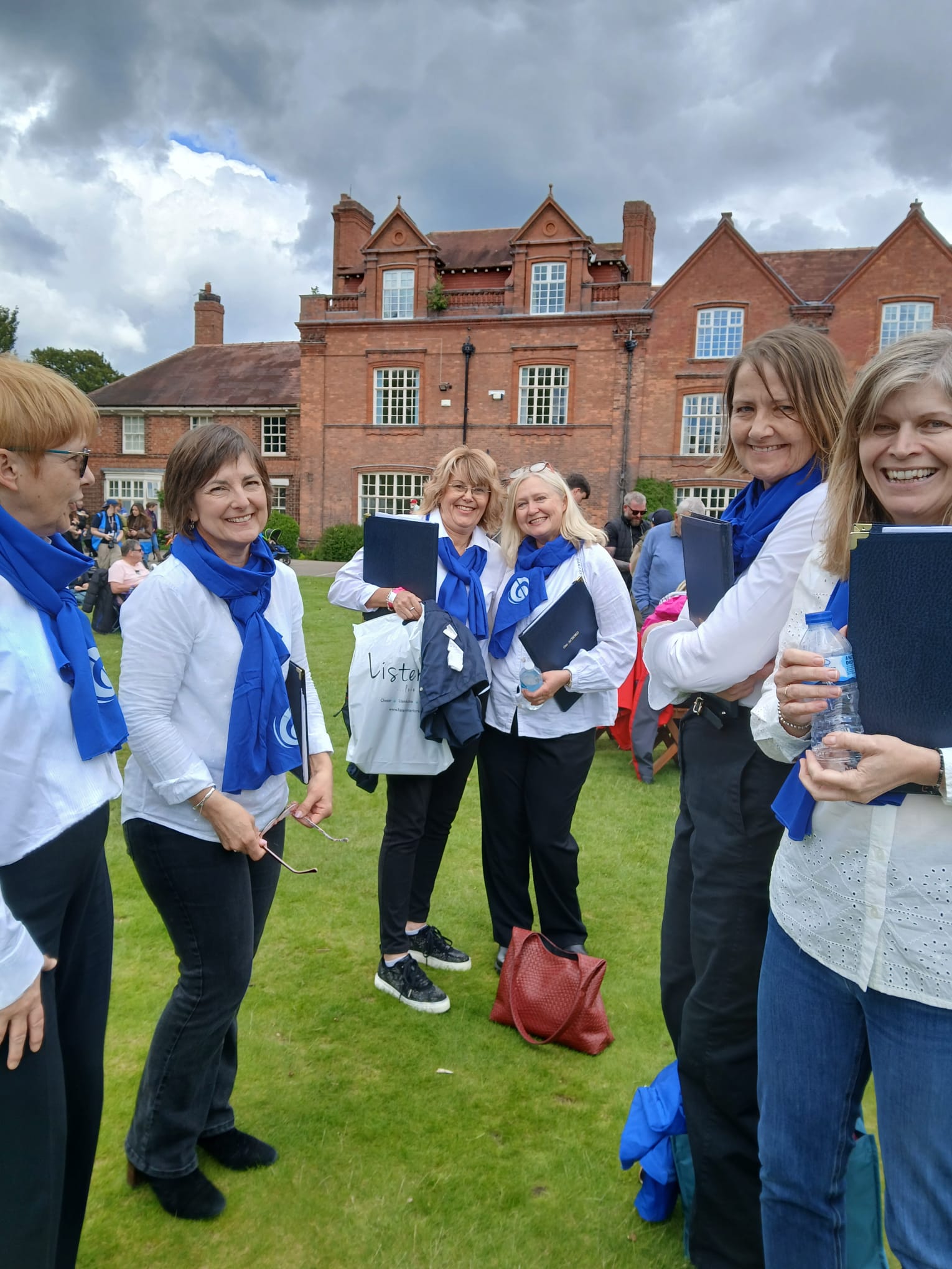 One Achord members smiling together outdoors at a summer event.